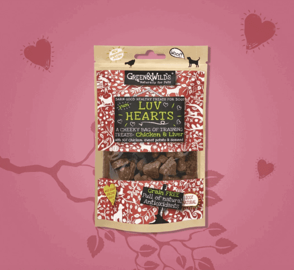 A package of GW LUV HEARTS, 100g dog treats sits on a pink heart-themed background. These grain-free, chicken and liver-flavored, heart-shaped delights are rich in natural antioxidants, perfect for showing your pet extra love.