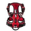 Red and black padded dog harness with adjustable straps, sturdy buckles, and metal leash attachment points. The harness features a label with a dog logo and is designed for comfort and secure fit.
