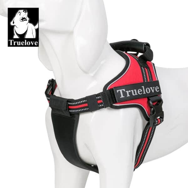 A white dog mannequin wears the Truelove Dog Handle Harness—lightweight, reflective, strong—in red and black with a back handle. The Truelove logo appears in the upper left corner.