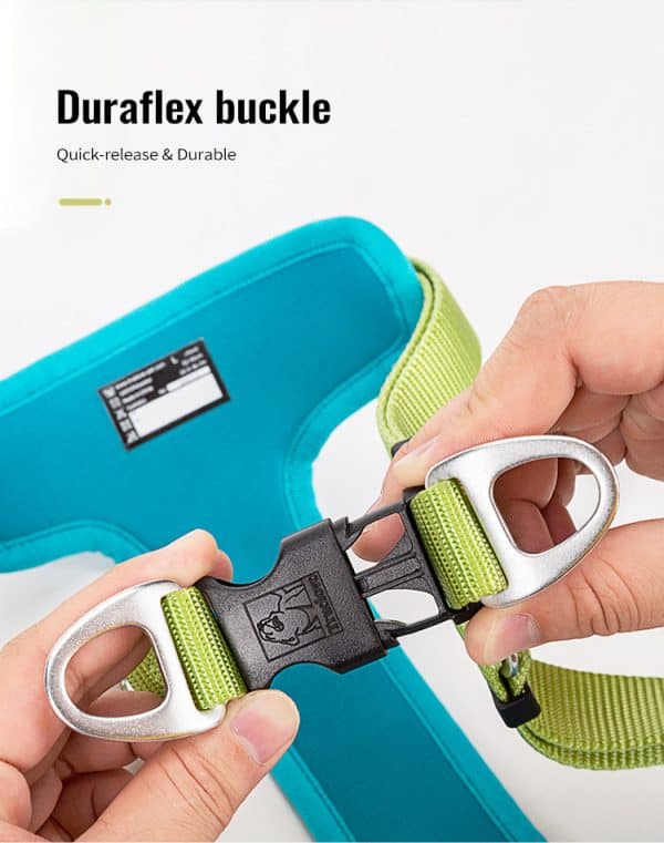 A close-up of hands fastening a black and silver Duraflex buckle with green straps on the TLH5951 Pet harness in blue. Text: "Duraflex buckle – Quick-release & Durable.