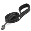 The TLL 2111 110 cm Dog Lead, soft, is a black leash with a padded loop handle and reflective stitching, featuring a metal clip for easy attachment to a collar or harness. It is shown coiled neatly on a white background.