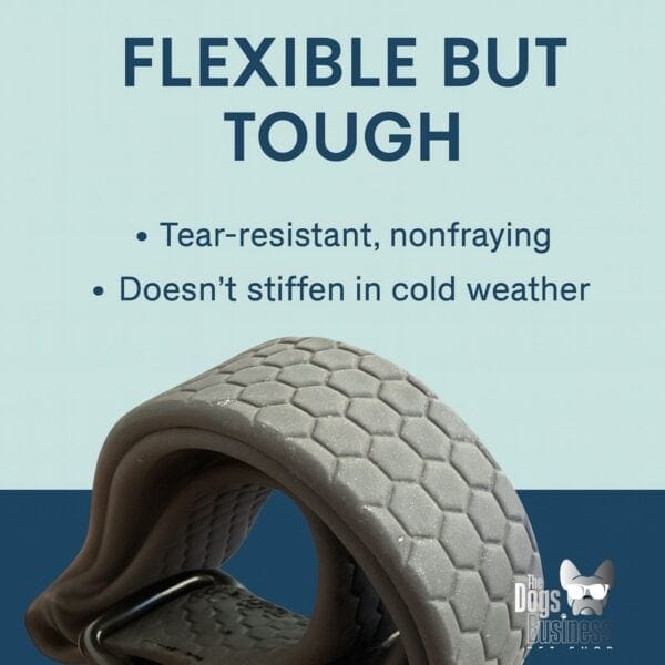 A close-up of a gray, textured dog collar bent to show flexibility. Text above reads: "Flexible but tough: Tear-resistant, nonfraying. Pairs perfectly with our Waterproof Double-Ended Adjustable Dog Leash (1.8 m)." The Dog’s Business logo is bottom right.