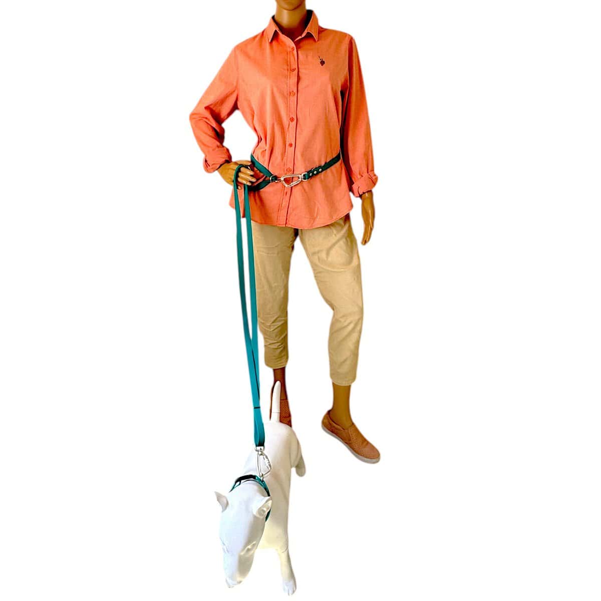 A mannequin in a coral button-up shirt, beige trousers, and slip-on shoes holds the WAVE 8-in-1 Hands-Free Waterproof Adjustable Dog Lead – 2.5m with a steel carabiner, attached to a white dog mannequin. Both are set against a plain white background.