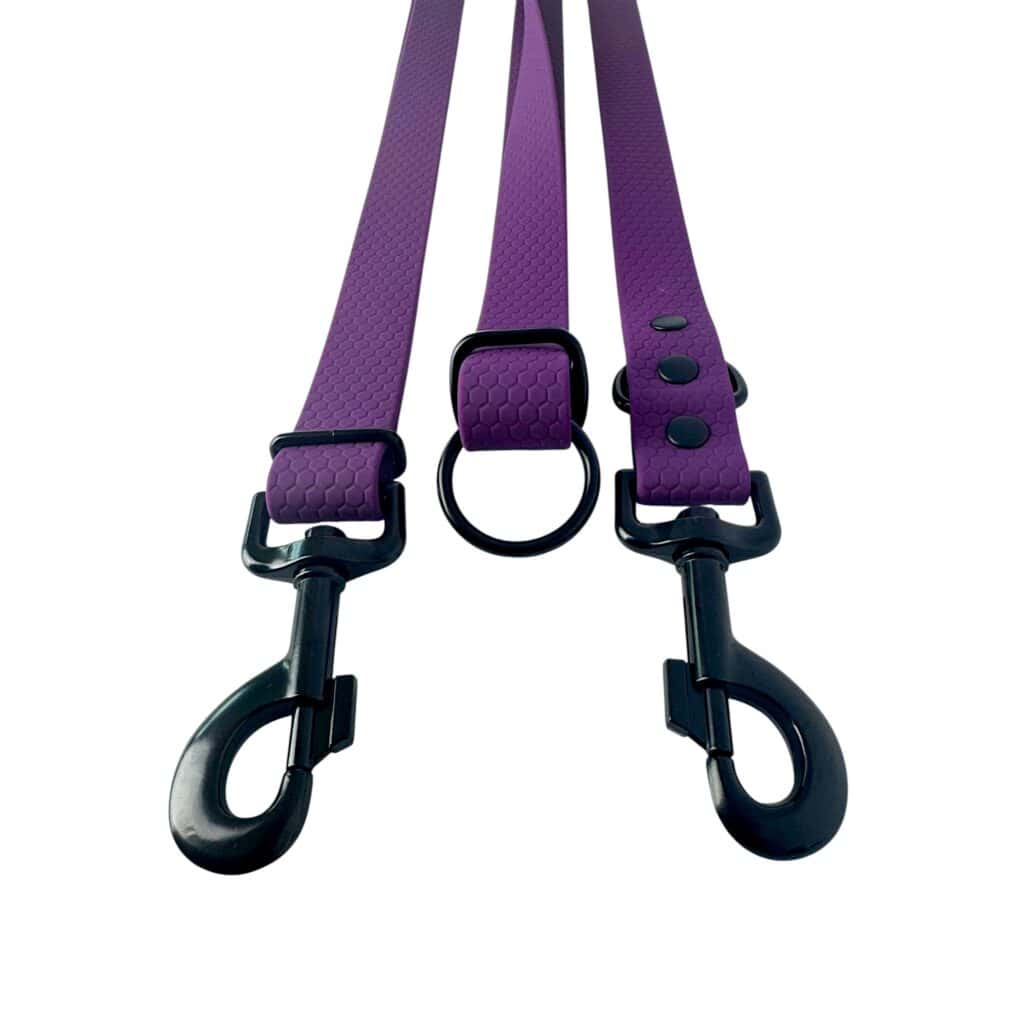 Two purple WAVE Hands-Free Leads with black metal clips and a central black ring, displayed on a white background. Each lead has a textured pattern and three black rivets by the ring.