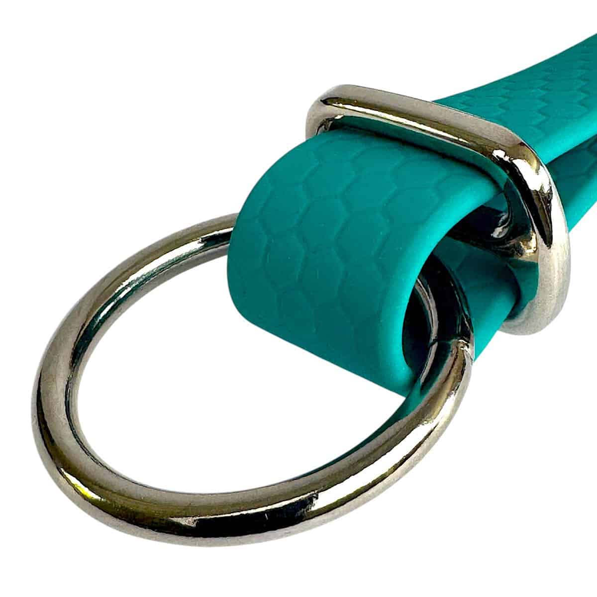 A close-up of a teal dog collar with a hexagonal pattern and shiny silver hardware, perfectly paired with the WAVE Hands-Free Lead for versatile walks.