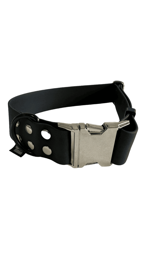 A BLACK colored Wide Waterproof Buckle Collar - Metal edition, Biothane™, W 38 mm with a silver clasp and metal eyelets. The distinctive metal edition features double loops for additional fastening support. The image showcases the strap slightly coiled to display both the buckle and loops.