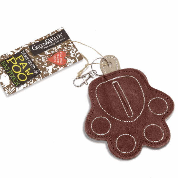 The Green & Wilds Poo Bag Pouch is a brown, paw-shaped felt carrier for dog waste bags with stitched details and a metal leash clip. Its tag displays "Green & Wilds Poo Bag Pouch" in a stylish decorative design, offering practicality and style.