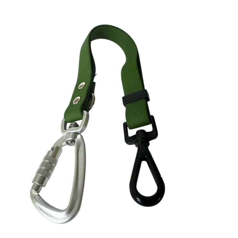The Freedom Handle is designed with a green strap featuring a silver locking carabiner on one end and a black plastic swivel hook on the other, making it perfect for hands-free dog walking, multi-dog control, or securely attaching and carrying items with ease.
