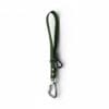 A Freedom Handle in green fabric, featuring a metal carabiner and black plastic clip, designed for hands-free dog walking and convenient multi-dog control, shown isolated on a white background.
