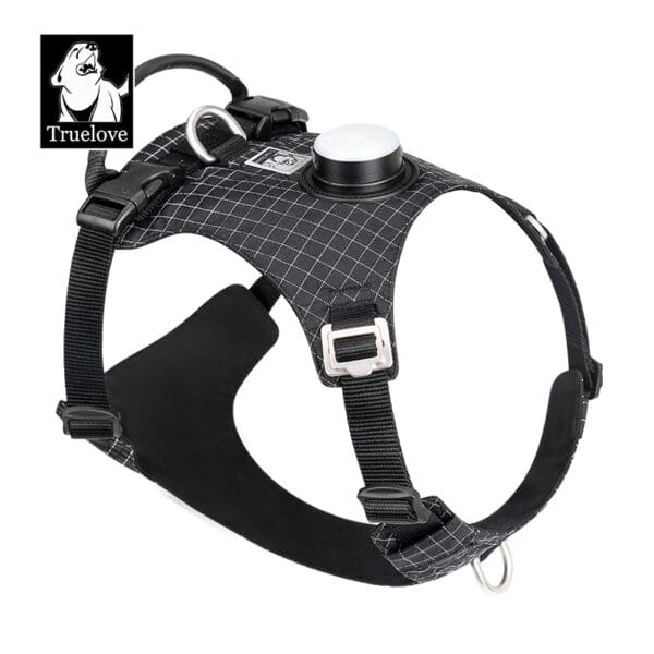 The Truelove TLH6771 LED Dog Harness - GPS Tracker Smart Safety, shown in black and gray with reflective stitching, sturdy handle, metal rings, circular tag holder, and logo with dog illustration, is displayed on a white background.