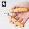 A hand holds a Bamboo Pet Nail Clipper with Safety Guard – Dog & Cat Grooming, featuring wooden handles and a metal blade. The Truelove logo is visible in the top left corner.