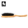 A side view shows the Truelove Bamboo Pet Brush – Dual-Action Grooming Comb for Dogs & Cats, featuring a wooden handle and black bristles. The top left corner displays a black and white "Truelove" dog head logo.