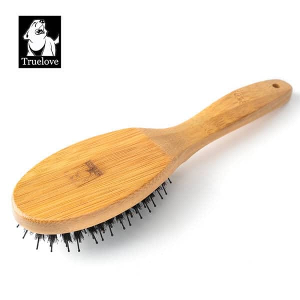 The Truelove Bamboo Pet Brush – Dual-Action Grooming Comb for Dogs & Cats, featuring black bristles and a wooden handle, is pictured on a white background with the Truelove logo and dog illustration in the upper left corner.