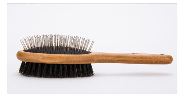 Truelove Bamboo Pet Brush with Boar Bristle - closeups The Truelove Bamboo Pet Brush features a wooden handle, boar bristles on one side, and stainless steel pins with rounded tips on the other, displayed against a plain white background.