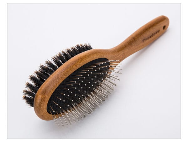 Truelove Bamboo Pet Brush with Boar Bristles - Main The Truelove Bamboo Pet Brush features a wooden handle with "Truelove" engraved, stainless steel pins with rounded tips on one side, and dense boar bristles on the other.