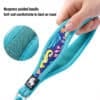 A hand holds the Truelove TLL25761 Outdoor Dog Leash, featuring a light blue neoprene padded handle with a soft, colorful lizard and leaf pattern. Inset shows close-up detail. Text: "Neoprene padded handle. Soft and comfortable to hold.