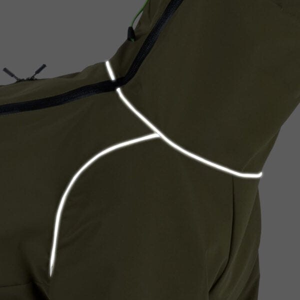 A close-up of the reflective strips on the green windproof dog jacket, highlighting safety features.