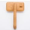 A Truelove Bamboo Pet Comb - Grooming Tool with a long handle and rectangular head, placed on a white surface. The head features an engraved logo of a chef's hat with the word "Travelbao.