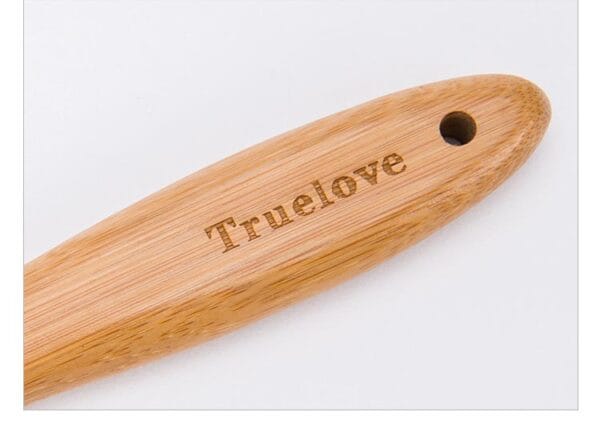 A close-up of the Truelove Bamboo Pet Grooming Brush’s wooden handle, featuring a hole near one end and "Truelove" engraved on it, with stainless steel pins for pet grooming.