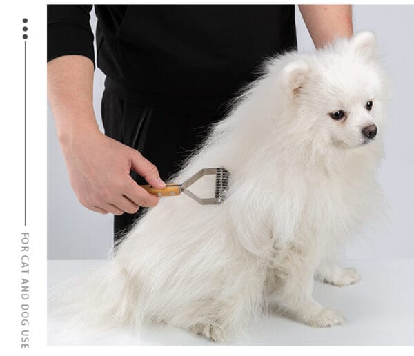 A person brushes the long, fluffy white fur of a small dog, possibly a Pomeranian, using a grooming tool. The dog sits calmly on a white surface. Text on the image reads, "FOR CAT AND DOG USE.