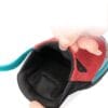 A close-up of a hand opening the back of the Truelove Adventure Paw Dog Shoes - Reflective & Anti-Slip Comfort TLS4862 in red and teal, revealing the black padded interior and cushioned heel area.