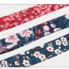The Truelove Functional Dog Leash with Neoprene Handle TLL3112 features three stylish fabric ribbons: red with white flowers, dark blue with pink lilies and red accents, and navy with white and red cherry blossom designs.