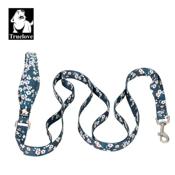 The Truelove Functional Dog Leash with Neoprene Handle TLL3112 features a blue base with white and pink florals, metal clasps on both ends, and a black "Truelove" logo with a dog’s head in the corner.