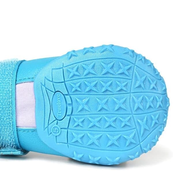 Close-up of the bottom of a blue Truelove Waterproof Outdoor Pet Shoe - Reflective Strap TLS3963, featuring a textured rubber sole with X-shaped treads and "Truelove" embossed near the center.