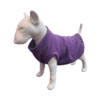 A small white dog mannequin wears the Fleece Dog Sweater | Warm Winter Vest for Dogs & Cats in purple, standing with its tail up against a plain white background.
