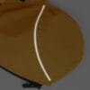 A close-up of the Waterproof Dog Raincoat shows its yellow fabric with a curved reflective strip and a zipper at the bottom, displayed on a grey background.