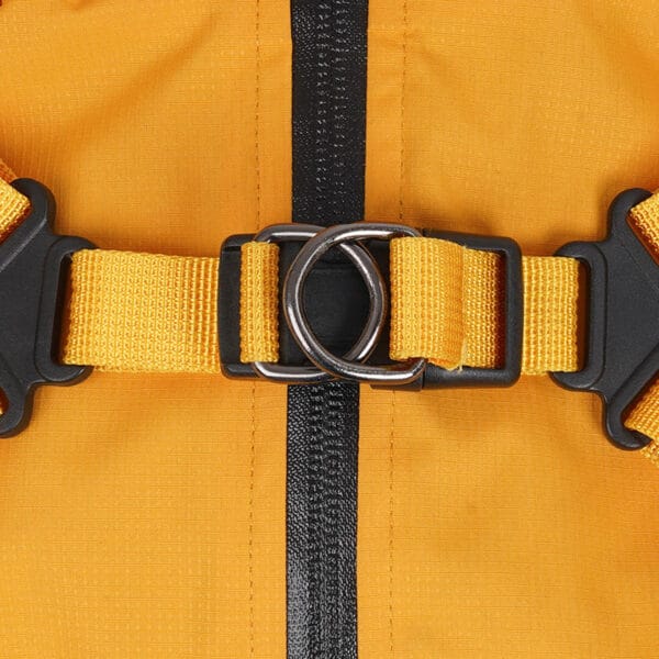 Close-up of the Waterproof Dog Raincoat - Reflective & Breathable Pet Jacket, showing its yellow strap with black buckle and metal ring, securely fastened on orange fabric with a vertical black stripe.