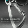 Close-up of a silver carabiner clip with a locking mechanism, set against a grey background. Perfect for Premium Waterproof Dog Gear UK. Text on the image reads: "Premium Hardware. Strong. Reliable. Secure.
