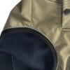 Close-up of the TDB light Jacket's tan waterproof fleece-lined sleeve, featuring a black elbow patch, dark press stud on the cuff, and showcasing detailed stitching and fabric texture.