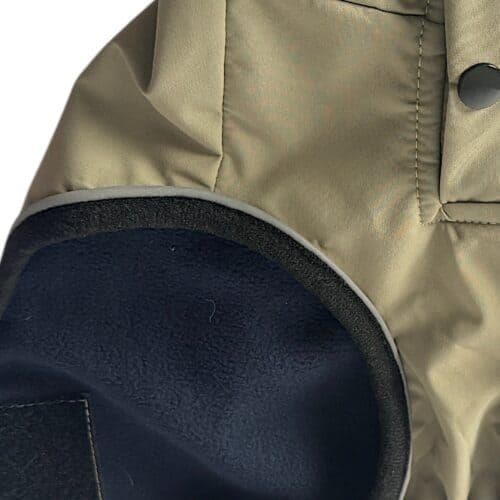 Close-up of the TDB light Jacket's tan waterproof fleece-lined sleeve, featuring a black elbow patch, dark press stud on the cuff, and showcasing detailed stitching and fabric texture.