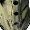 Close-up of the TDB light Jacket, a khaki waterproof, fleece-lined dog coat featuring four large black buttons in a vertical row, visible stitching, and two angled front pockets.