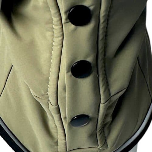Close-up of the TDB light Jacket, a khaki waterproof, fleece-lined dog coat featuring four large black buttons in a vertical row, visible stitching, and two angled front pockets.