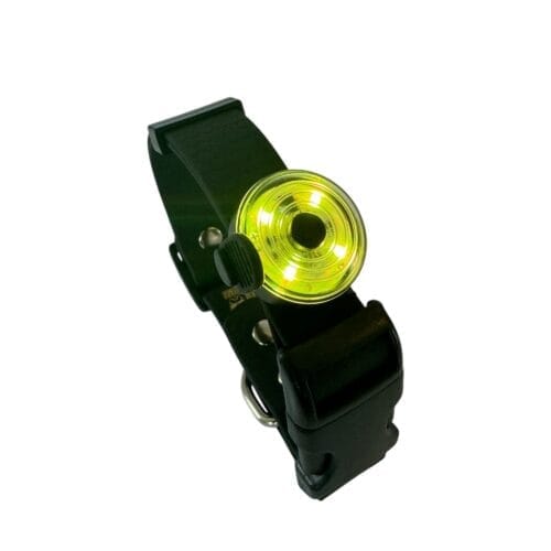 The Dogs Business Safety Light is a black adjustable strap featuring a round, glowing yellow LED, ideal for pet safety or outdoor activities.