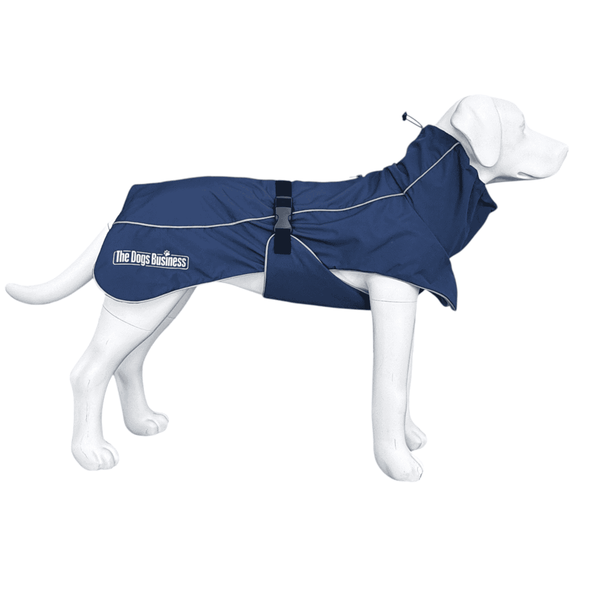A white dog mannequin is wearing the Alpine Winter Jacket, a blue dog raincoat with a black buckle and a logo that reads “The Dogs Business” on the side.