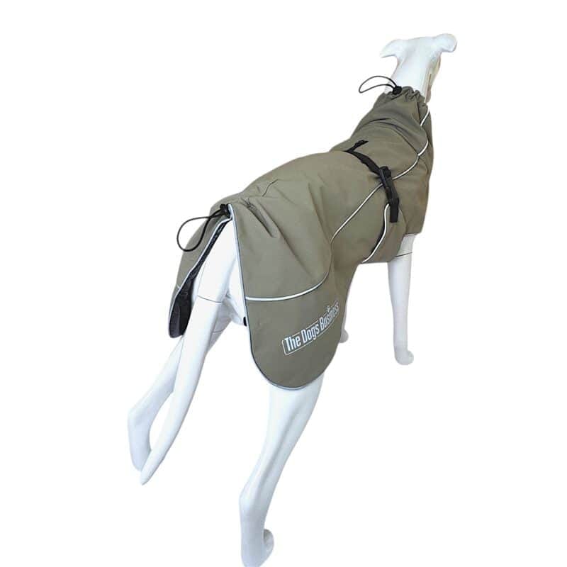 Coastal Jacket Light dog coat in olive green on a white mannequin, featuring white piping, black buckle straps, and a logo that reads “The Dogs Business”.