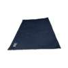A rectangular dark blue velour snuggle blanket with a light-coloured trim and a small rectangular patch in one corner.